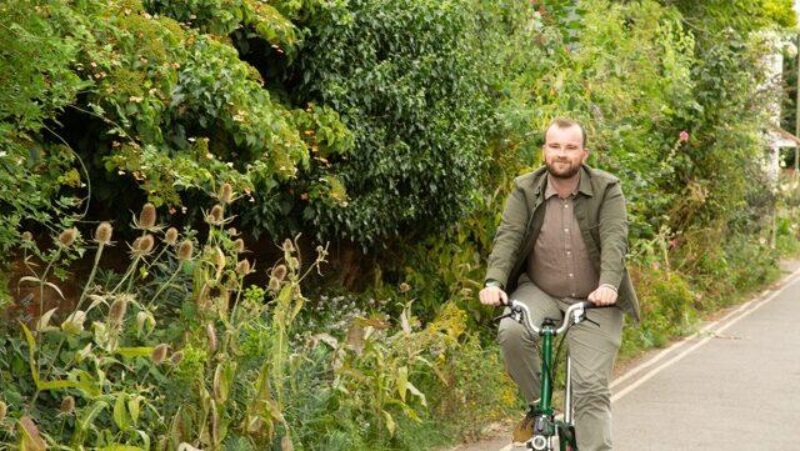 Cllr Brad Baines cycling on his bike